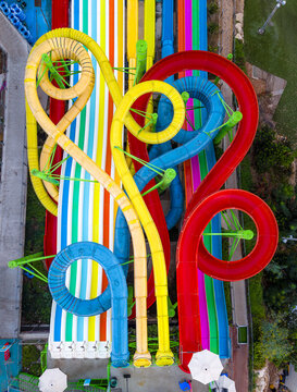 Aerial view of the colorful water slides at Shefayim Water Park with vibrant red, yellow, and blue tubes winding over the grounds in Shefayim, Center District, Israel.