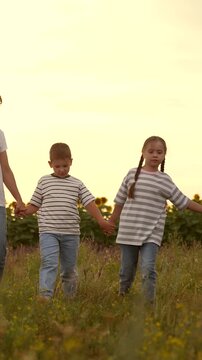 mother father children boy girl park sunset, man woman toddlers outdoors, Family walking in the field at sunset, Parents with children outdoors, Happy family time together, Summer vacation in nature