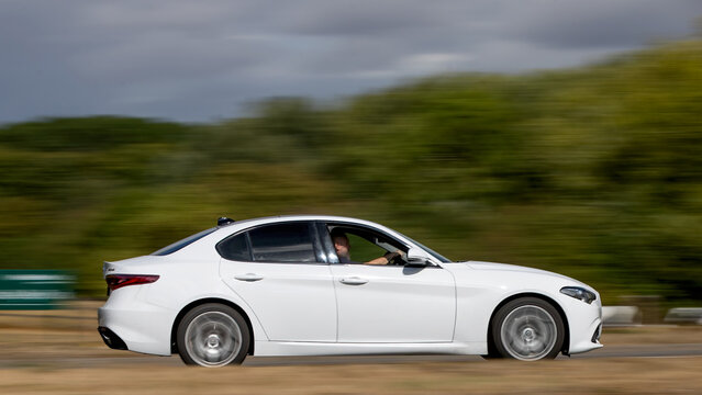 Milton Keynes; UK - Aug 26th 2026: white Alfa Romeo Giulia   car driving on a British road