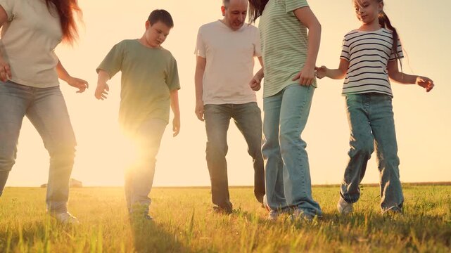 Parents run with child kid playing football green lawn, children kicking ball, mother father girl boy happy family sunset, joyful countryside leisure, casual jeans, optimistic summer energy., healthy