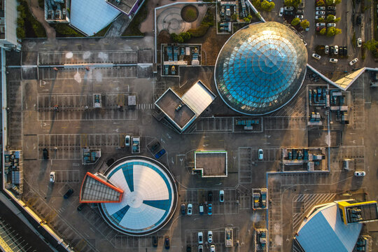 Aerial view of Aeon Mall featuring distinctive glass domes, rooftop parking areas, and surrounding urban infrastructure in Suzhou, Jiangsu, China.