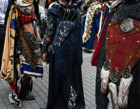 Medieval warriors in costume take part in a festival parade in Spain with detailed armor and accessories
