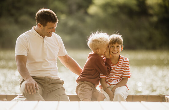 Joyful moments by the lakeside with family in the warm afternoon sun