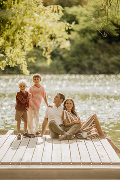 Family enjoying a sunny day by the tranquil lakeside