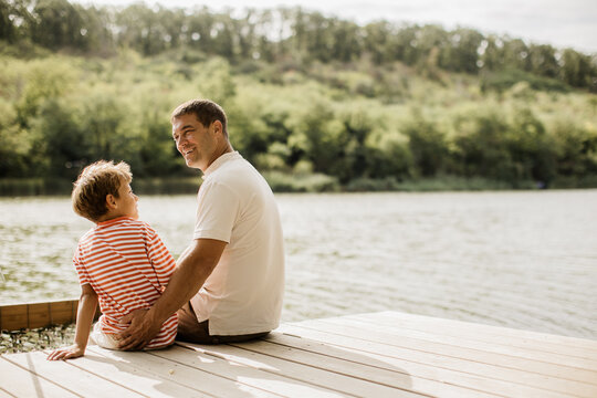 Joyful moments by the river with father and son enjoying nature's beauty