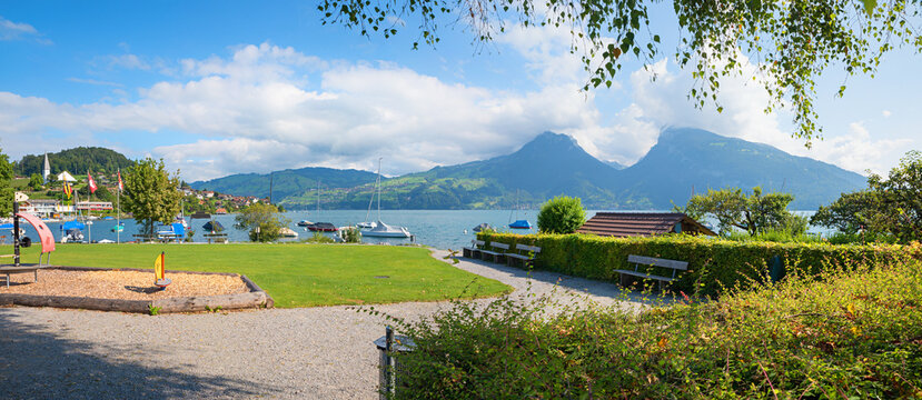 playground and public bathing lawn, tourist resort Faulensee, lake Thunersee switzerland