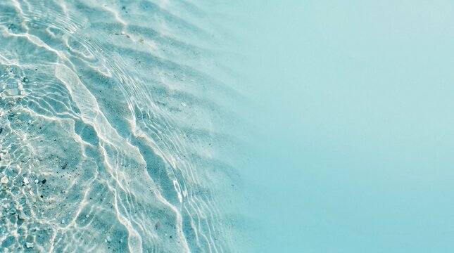 Crystal Clear Turquoise Water Over Rippled Sand