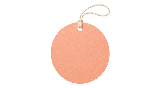 Blank round peach colored paper gift tag with a natural twine string on white background