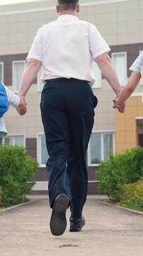 child kid holding father hand running with backpacks school, happy family, view from back, child kid girls parent father run lessons, bell lesson, man child leads school lesson, concept happy family