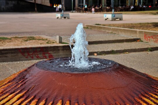 Wiesbaden, Hesse, Germany: Close up of Kochbrunnen thermal spring water bubbling from distinctive red mineral deposits.