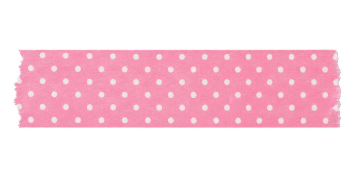 A strip of pink washi tape with a white polka dot pattern isolated on a clean white background