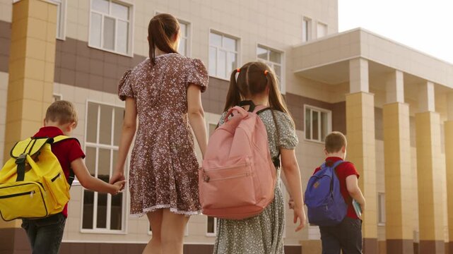 School days begin, Loving parents by their side, Backpacks full of supplies, Open doors to knowledge, Beautifully designed building, School morning rituals, Holding hands for support, Siblings united