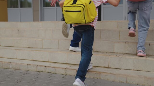 Happy students on first day, Schoolyard arrival moment, Pupils wearing sneakers, Children entering educational building, Primary school students, Children climbing steps, Kids preparing for lessons