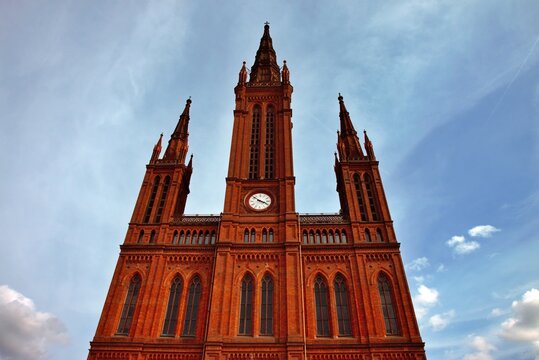 Wiesbaden, Hesse, Germany: Upper facade and towers of Marktkirche featuring neo-Gothic red brick architecture and central clock.