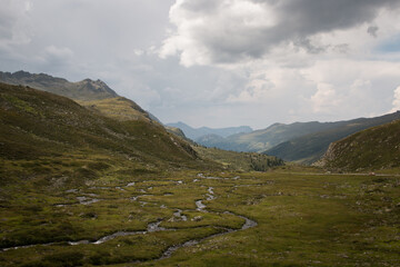 Scenic view over mountain valley with winding glacial river in Swiss Alps © hendrikwolter