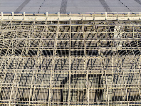 Aerial view of modern sports arena roof and distinctive architectural facade with complex structural design