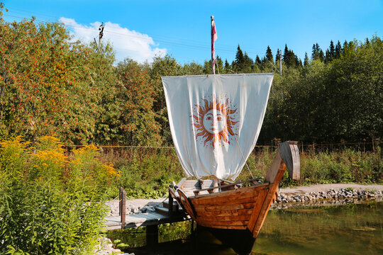 Wooden boat with sail on the river bank on a clear sunny day. Sights of Russia, World tour-ism.
