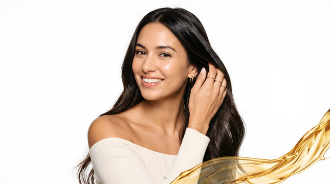 Woman running hand through hair wearing delicate rings beside golden oil splash background scene brightly