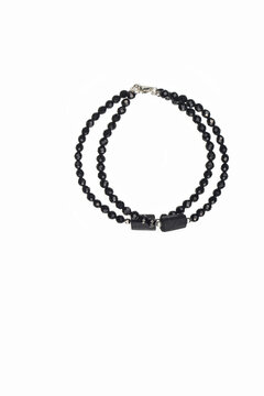 Double strand black spinel beaded choker necklace with tibetan dzi and lava stone beads isolated on a white background, ethnic amulet jewelry photography with copy space