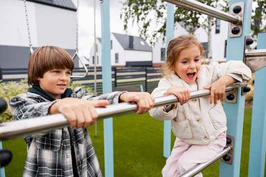 Children playing outdoor on playground monkey bars