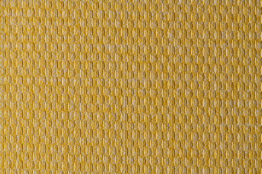 Yellow textured fabric texture background with geometric woven pattern