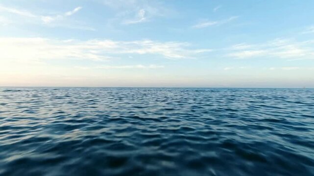 Calm ocean waves at sunset, serene blue sea horizon background, peaceful marine landscape for relaxation and travel projects
