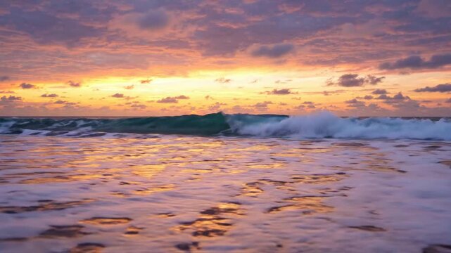 Tropical ocean sunset waves crashing on sandy beach at golden hour