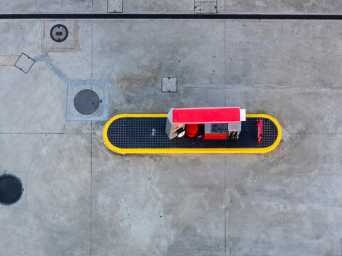 Aerial view of a petrol station pump island on a concrete surface in Cascais, Lisboa, Portugal.
