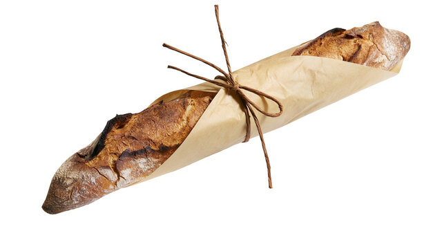Isolated freshly baked artisanal baguette bread wrapped in rustic brown paper and tied with twine