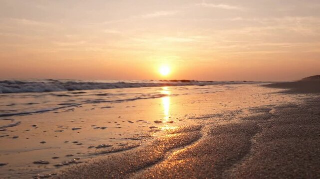 Golden hour sunset over tropical beach waves, serene ocean shoreline at dusk, peaceful coastal landscape background