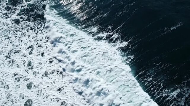 Aerial view of crashing ocean waves, powerful sea surf texture, blue water background, drone