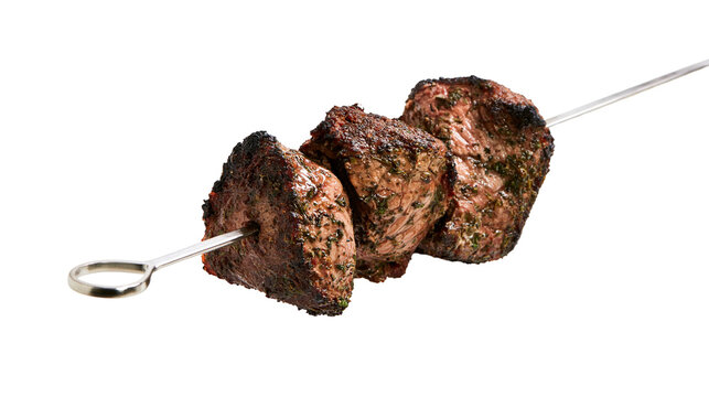 Isolated delicious savory grilled beef shish kebab skewer, succulent cooked meat for dinner meal