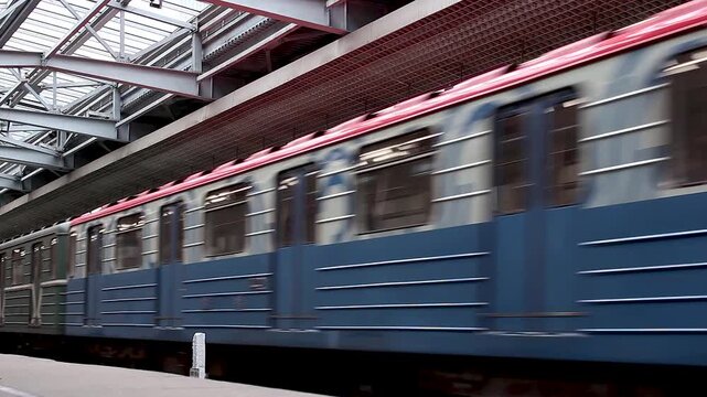 Vintage subway train moving fast through a metropolitan station