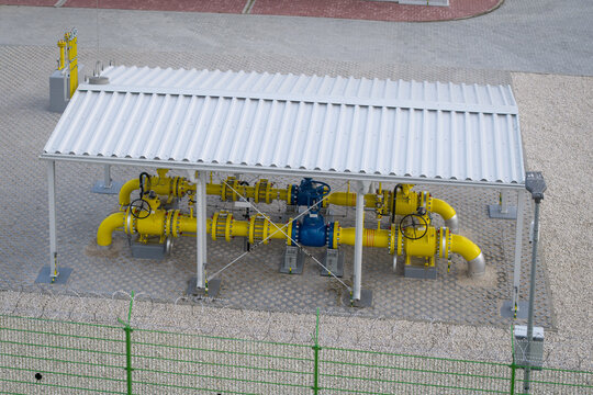 Aerial view of natural gas pipeline and pressure regulation equipment beneath a protective shelter