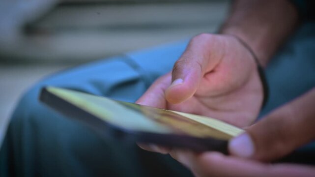 Restless youth endlessly doom scrolling social media feeds on a smartphone screen, scrolling habit