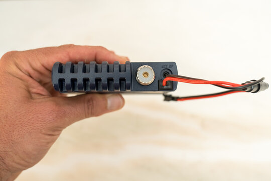 Small CB radio with sideband and female PL plug, safe in hand.