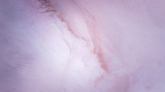 Aerial view of Hutt Lagoon Pink Lake showing abstract patterns of pink and white salt crust textures in Yallabatharra, Western Australia, Australia.