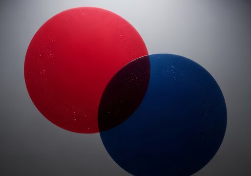 Massive crimson and dark sapphire circles overlap in a minimalist abstract composition, with tiny misty droplets coating the inner surfaces, geometric, macro, elegant