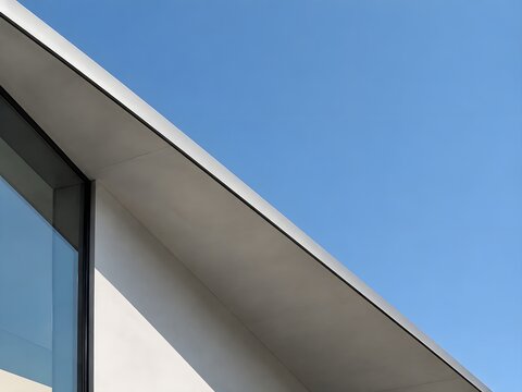 Roofline sloping dramatically against a clear sky showcasing modern minimalist geometry
