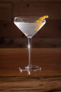 The classic Vesper Martini, served in a modern coupe glass on a wooden background.