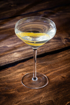 The classic Vesper Martini, served in a modern coupe glass on a wooden background.