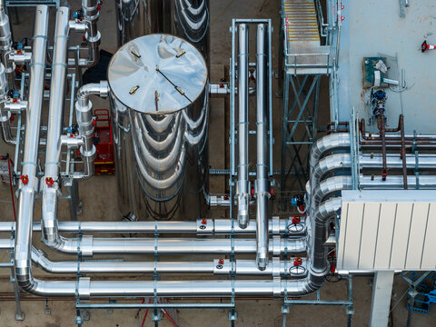Aerial view of industrial cooling infrastructure featuring stainless steel tanks and complex pipework at a data center in Sydney, New South Wales, Australia.