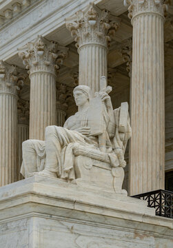 Justice statue marble monument. Supreme court facade columns symmetry. Law constitution judicial authority legislation. Legal concept background.