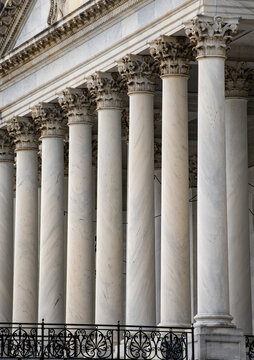 Columns stone Tall vertical marble. Columns architectural symmetry texture. Columns decorative capitals balusters detail. Columns classical American facade.