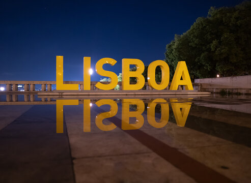 Lisboa Sign Reflected in Water at Night in Lisbon Portugal