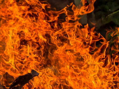 Intense blazing fire flames texture background with glowing orange and yellow sparks and heat.
