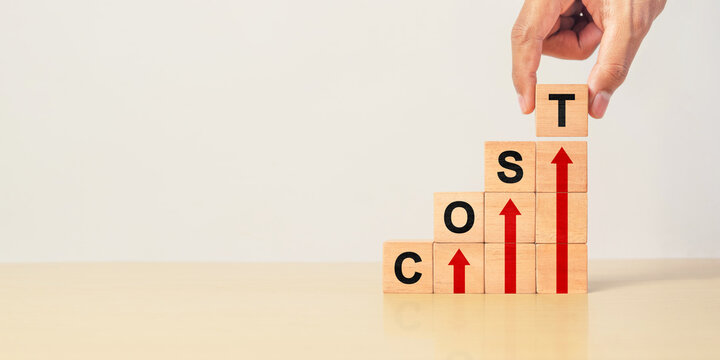 Cost increase and inflation concept. The word cost on wooden cubes with arrows going up.