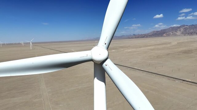 Large wind turbine generator standing in the desert landscape