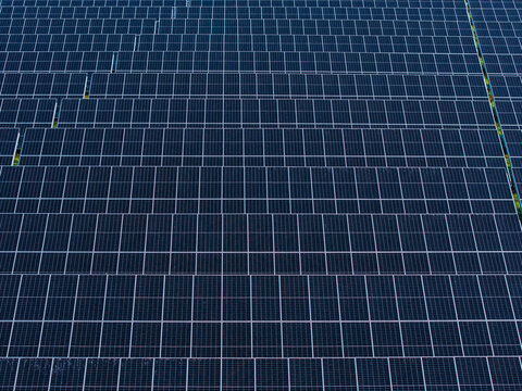 Aerial view of a large solar farm with rows of photovoltaic panels in Targale, Ventspils Municipality, Latvia.