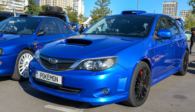 Vibrant blue Subaru Impreza WRX hatchback showcases its hood scoop and roof intake, a rally bred Japanese icon defining street tuning culture